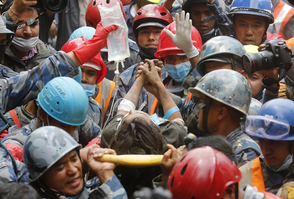 Earthquake survivor is rescued by the Armed Police Force from the collapsed Hilton Hotel, the result of an earthquake in Kathmandu