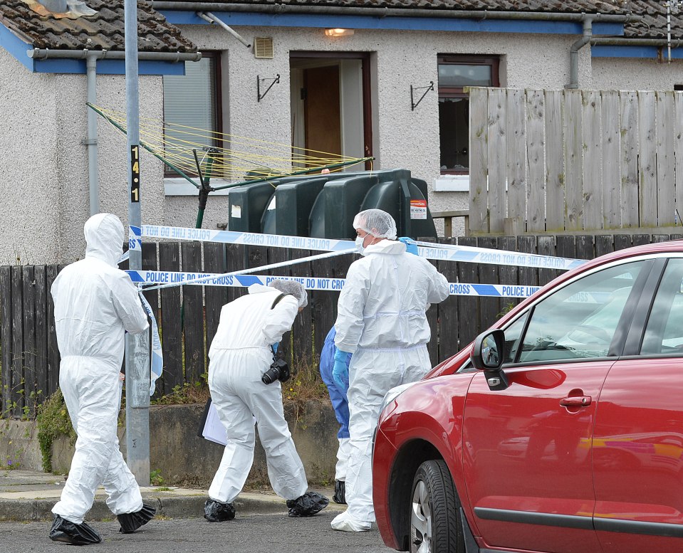 Forensic police work at the scene of the double killing in July last year