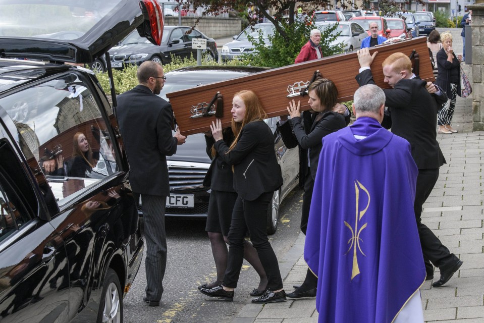 The coffin of John Yuill is carried to the hearse following his funeral at St Francis Xavier's RC Church in Falkirk, Scotland last year