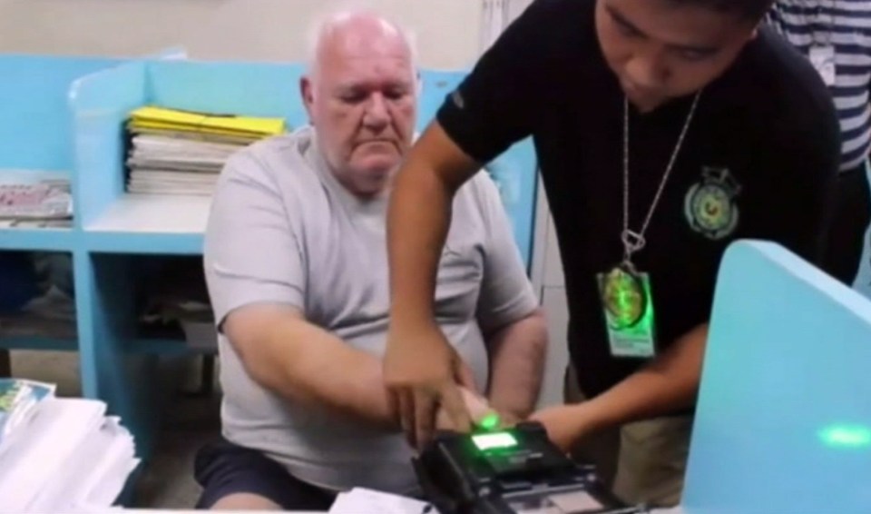 Slade is pictured here being deported from the Philippines in 2015 - the families of three kids he abused there and now taking groundbreaking legal action against him