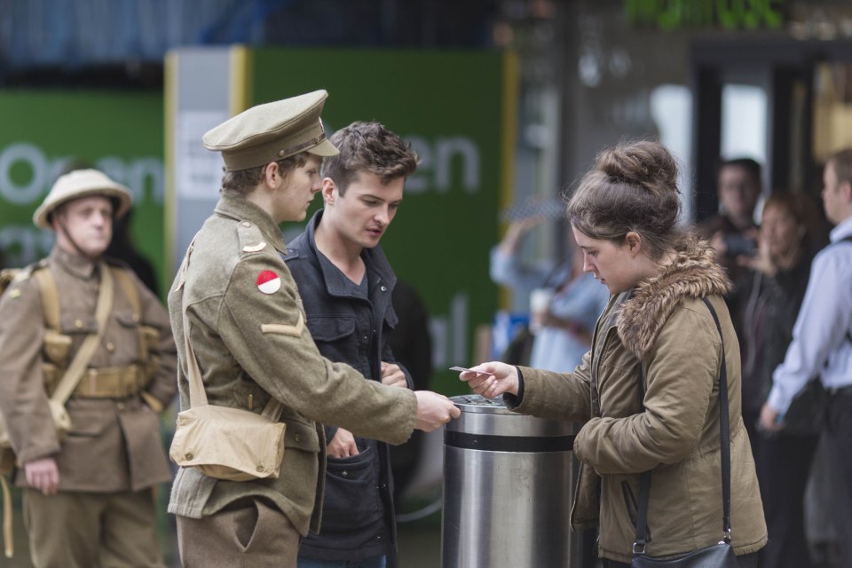 Members of the public were silently handed cards with names and details of one of the soldiers who lost their lives in WW1