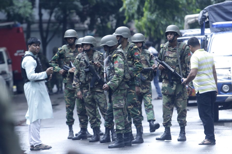 Soldiers stand guard this morning after about 100 commandos raided the restaurant last night