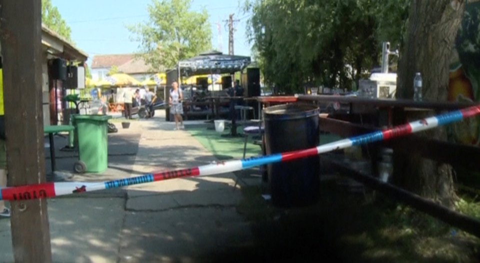 A police tape cordoned off the area outside the cafe after the shooting in the village of Zitiste, Serbia