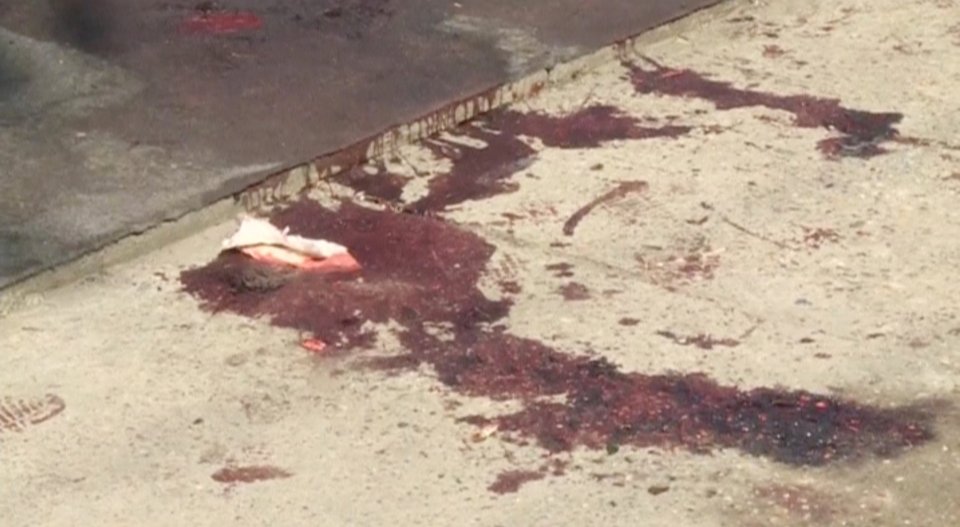 Blood stains on the ground at a cafe after a shooting during a local festival in the village of Zitiste