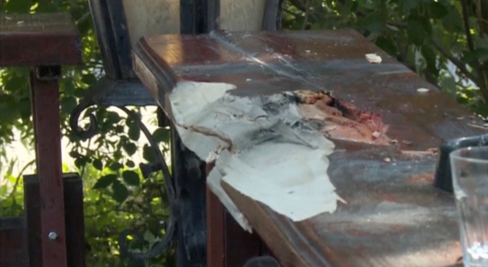 The cafe bartop was damaged after the jealous gunman opened fire, spraying bullets in the crowded area