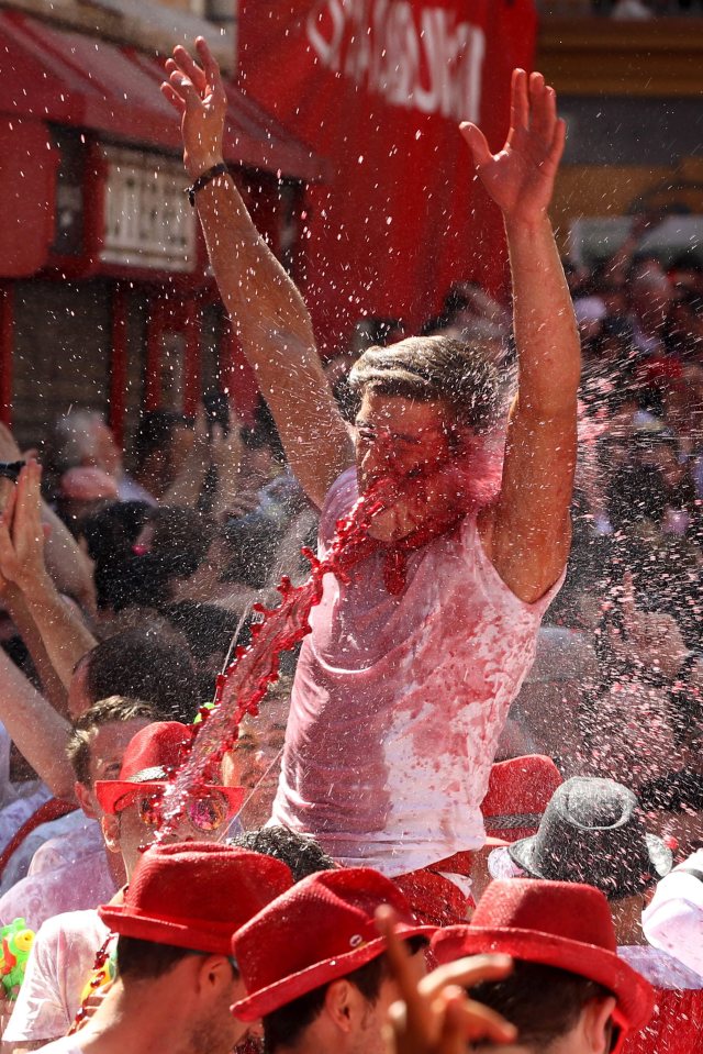 One reveller gets a face-full of wine as the free-flowing festival in the northern Spanish city of Pamplona