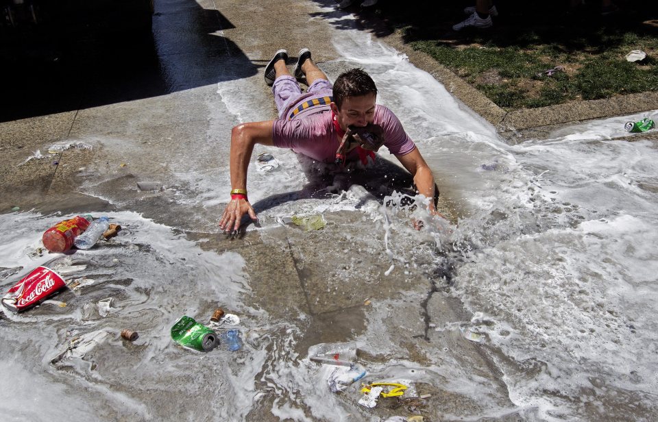 A man decided to slid along on his stomach after water was thrown down to clean the streets