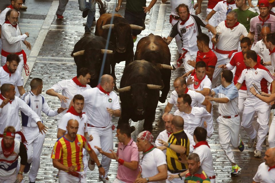 Thousands of thrill-seekers ran with the bulls through Pamplona, with one tactic to try to stay as close to the bull as possible