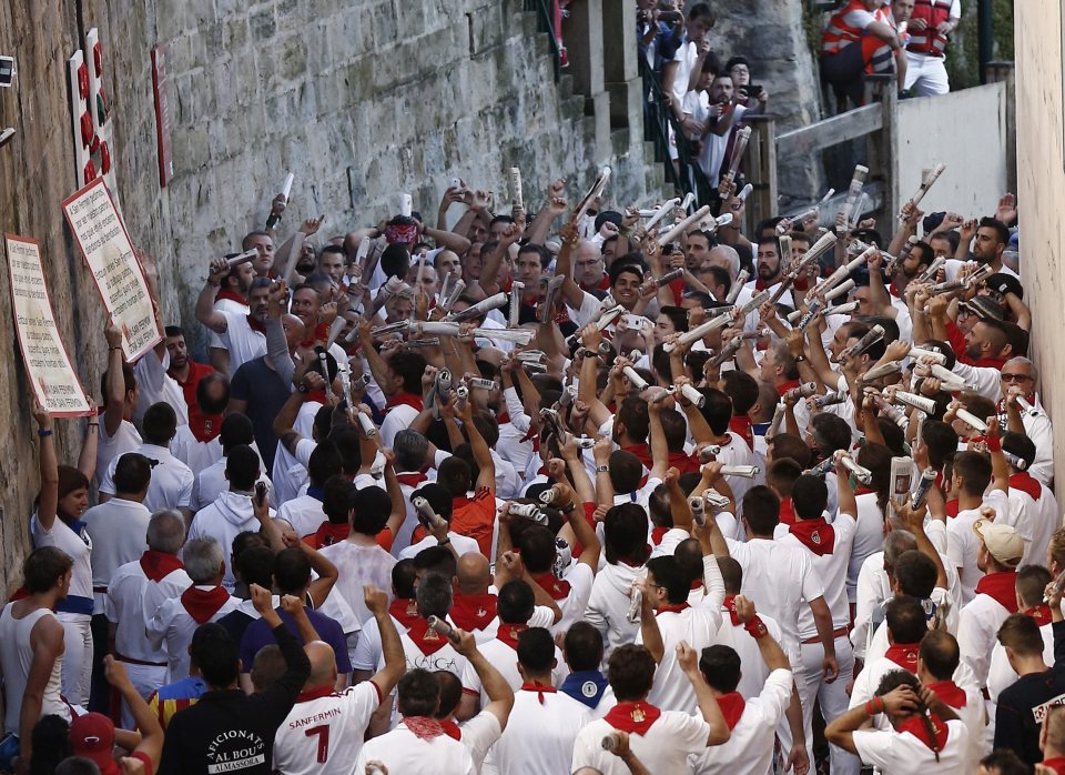 Runners perform the traditional song to St Fermin before the annual race begins