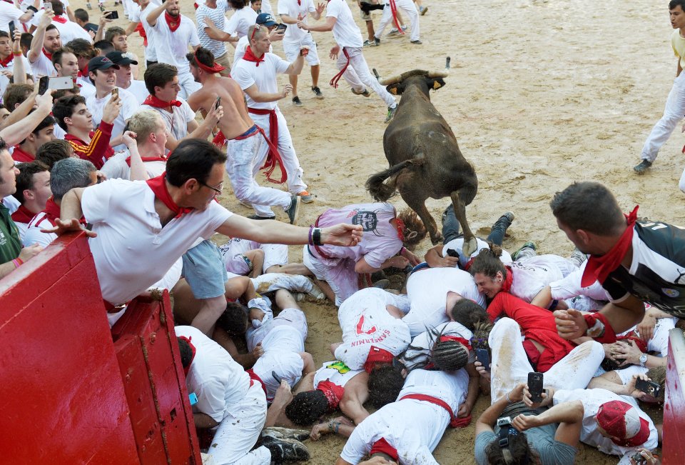 The runners must run down a narrow 930-yard course from a holding pen to Pamplona's bull ring