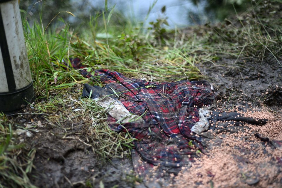 An item of clothing lies on the roadside near to where the car ploughed into the water