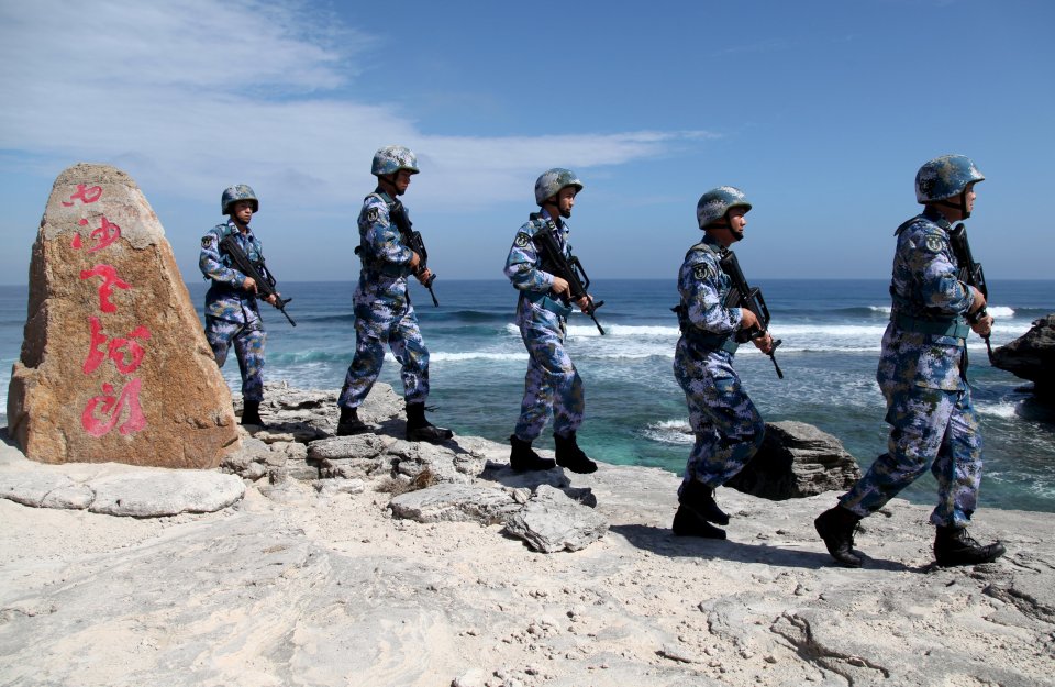 Soldiers of China's People's Liberation Army Navy patrol at Woody Island, in the Paracel Archipelago, which is known in China as the Xisha Islands