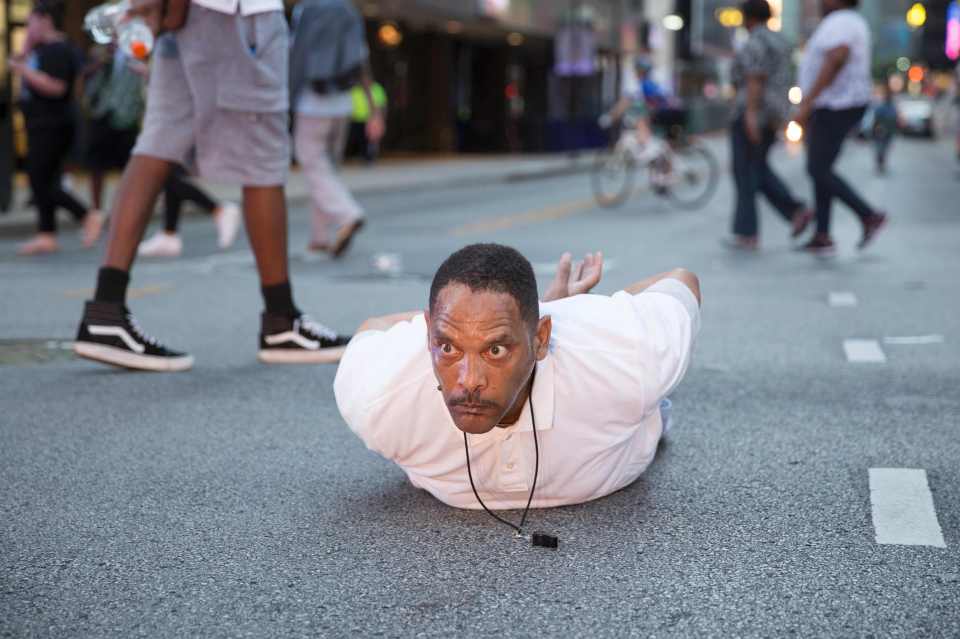A man lays on the ground after yelling "