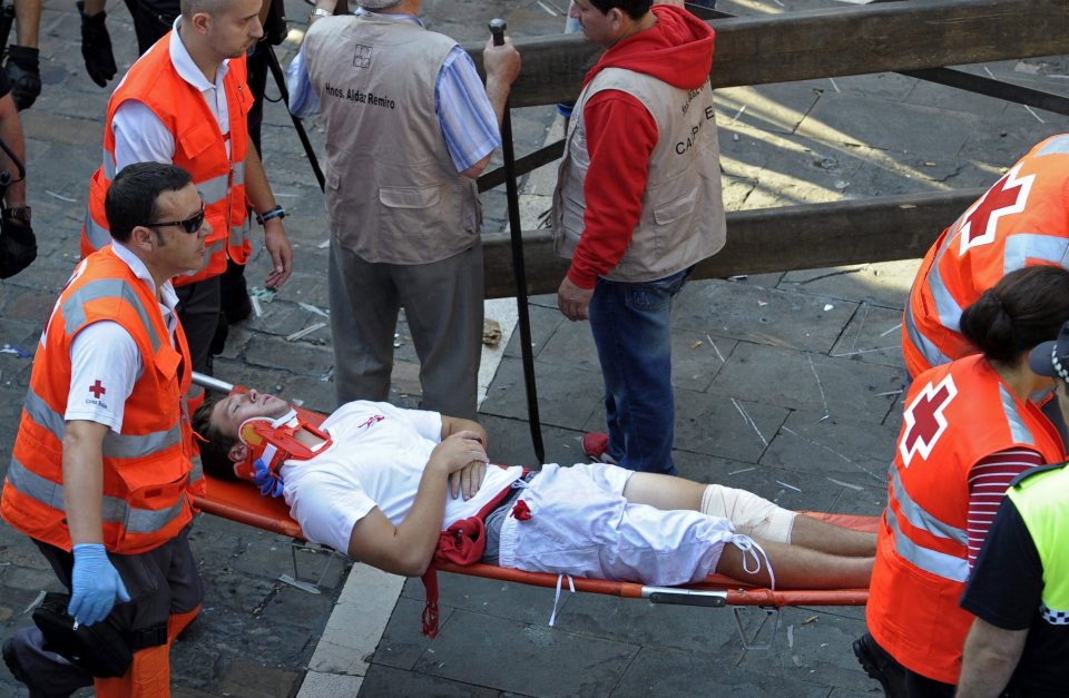 Red Cross staff members evacuate one of the runners who is treated with a neck brace