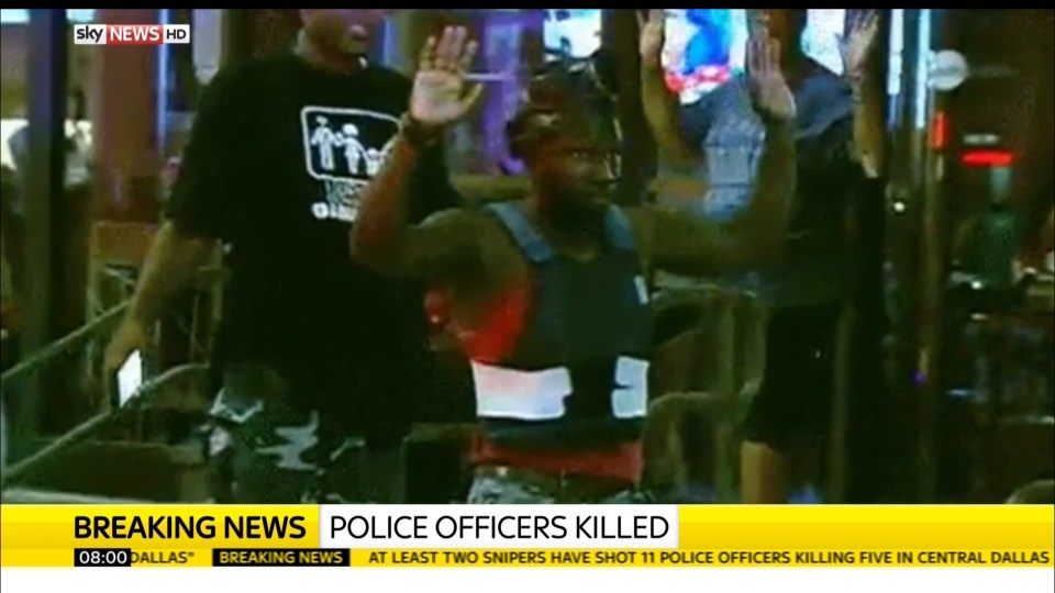 TV cameras caught the moment a man wearing a bullet-proof vest was arrested by armed police in Dallas