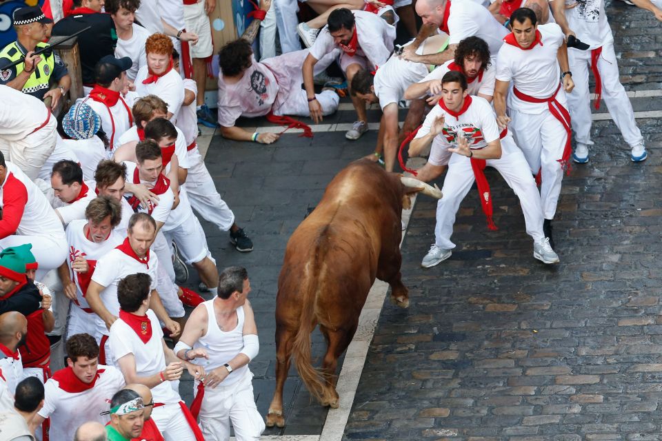 The first man was gored just seconds after the bulls were released from their pen on the second day of the nine-day festival