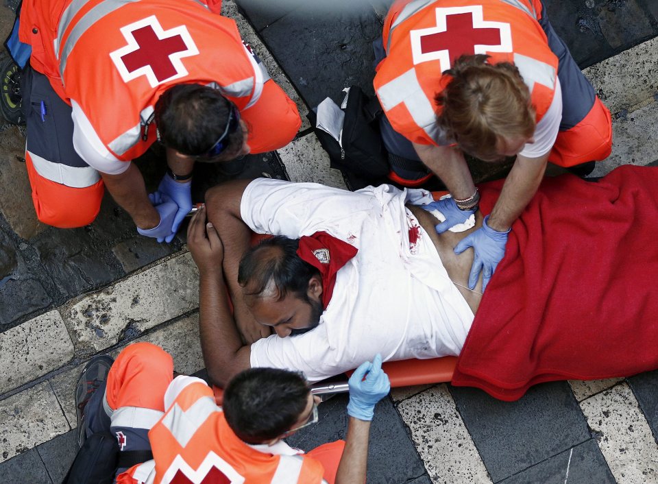 Medical staff treat an injured runner - it's a lucky escape for the man with 15 people dying since record-keeping began in 1924