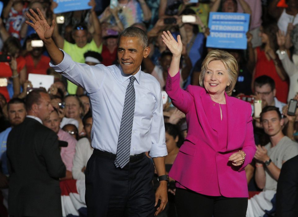 U.S. President Obama waves with Democratic U.S. presidential candidate Clinton at campaign event in Charlotte, North Carolina