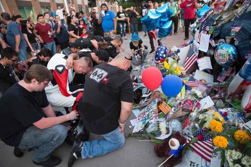 Mourners gathered in their hundreds to pay respects to the fallen police officers at the makeshift memorial in Dallas, Texas