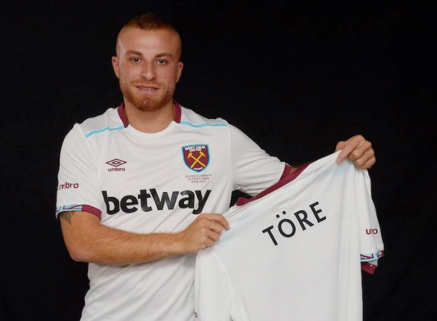 Gokhan Tore holds his new West Ham United shirt