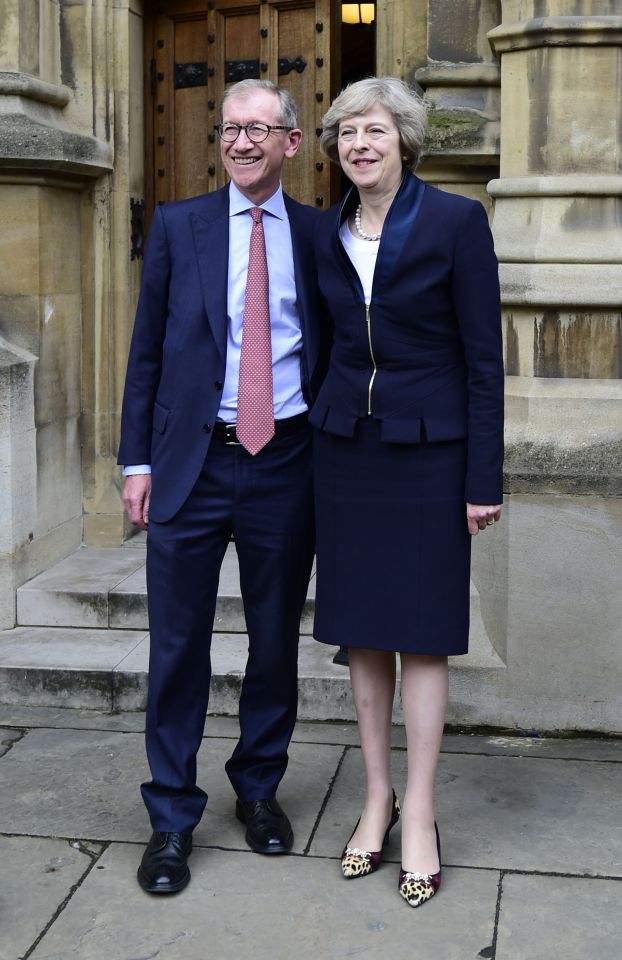 Theresa May posed with her husband Philip John outside the Houses of Parliament in Westminster after the incoming PM made a statement 