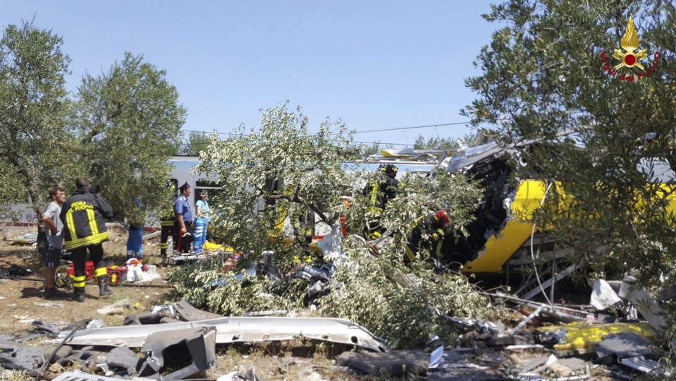 Emergency services work at the scene of the deadly train crash in Italy