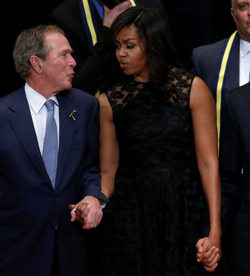 Former president George W. Bush, First Lady Michelle Obama and U.S. President Barack Obama sing during a memorial service following the multiple police shootings in Dallas
