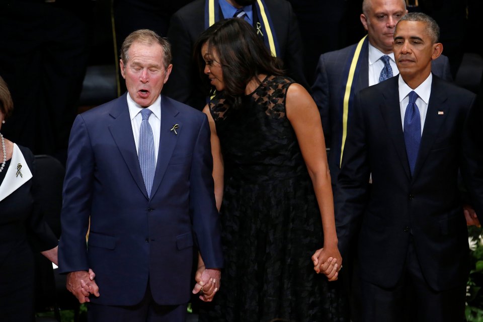 Former president George W. Bush, First Lady Michelle Obama and U.S. President Barack Obama sing during a memorial service following the multiple police shootings in Dallas