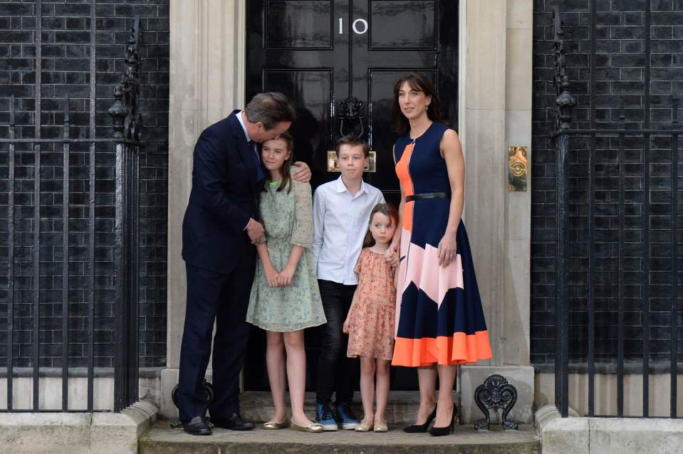 Cameron kisses his eldest daughter's head after his children, who are mostly shielded from the public eye, joined him for his final address as PM