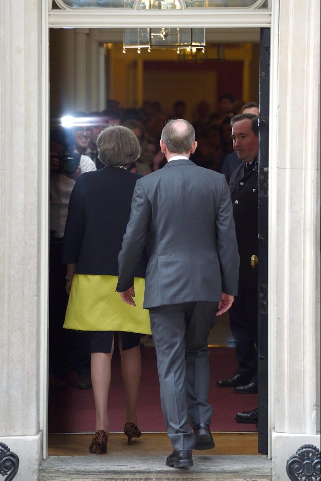 Theresa May walks into No10, followed by husband Philip, after being confirmed as the newest Prime Minister of Britain