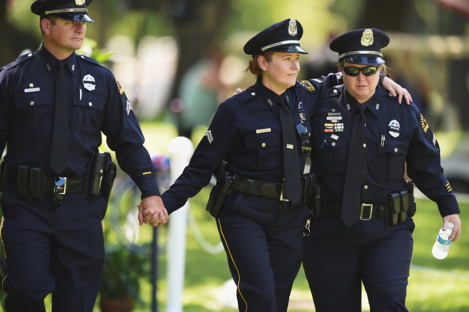 Officers leave the burial ceremony of Dallas Police Department Senior Corporal Lorne B. Ahrens, who was among five police officers shot dead the previous week, at Restland Public Safety Memorial Gardens in Dallas