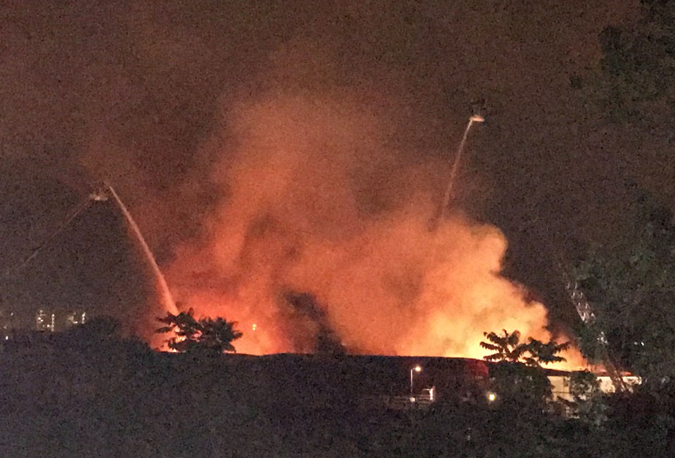 Sixty fire fighters tackled a blaze at an industrial estate next to the country's busiest railway station