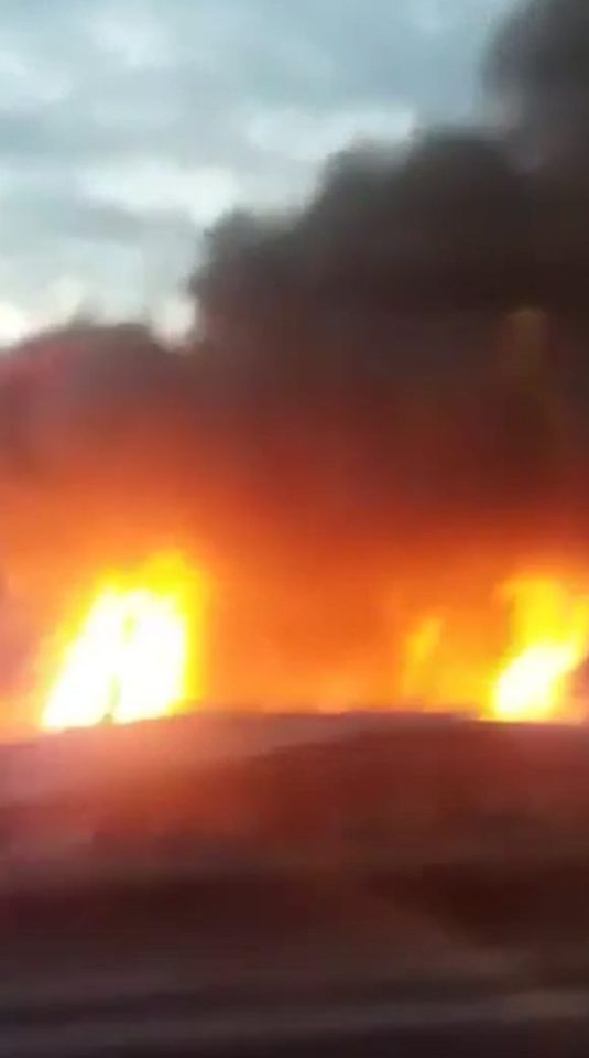 Flames soared above rooftops next to the railway line