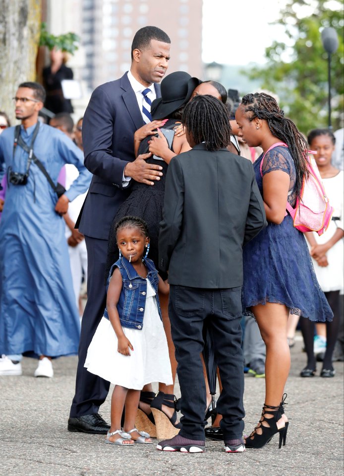 Diamond Reynolds' daughter looks on as the funeral procession for Philando Castile travels from the Brooks funeral home to the St Paul Cathedral in St Paul, Minnesota
