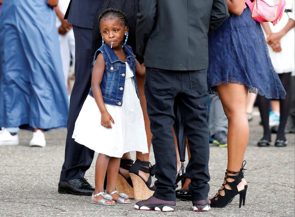 Diamond Reynolds' daughter looks on as the funeral procession for Philando Castile travels from the Brooks funeral home to the St Paul Cathedral in St Paul, Minnesota