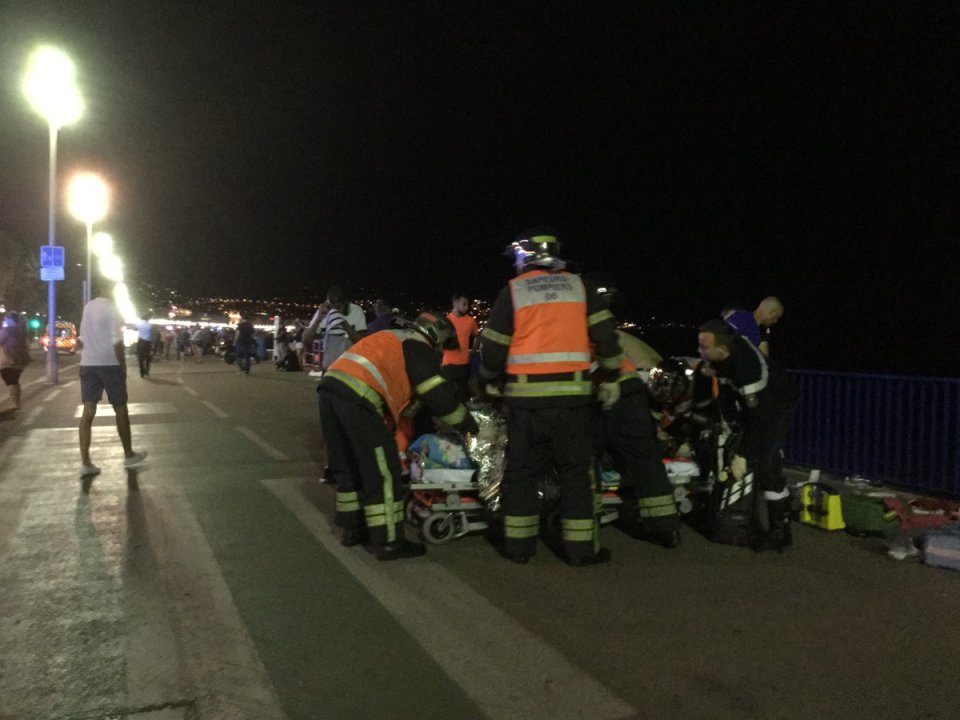 An injured individual is seen on the ground after at least 30 people were killed in the southern French town of Nice when a truck ran into a crowd celebrating the Bastille Day national holiday