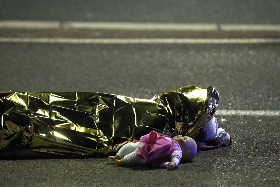 A body is seen on the ground after at least 30 people were killed in the southern French town of Nice when a truck ran into a crowd celebrating the Bastille Day national holiday