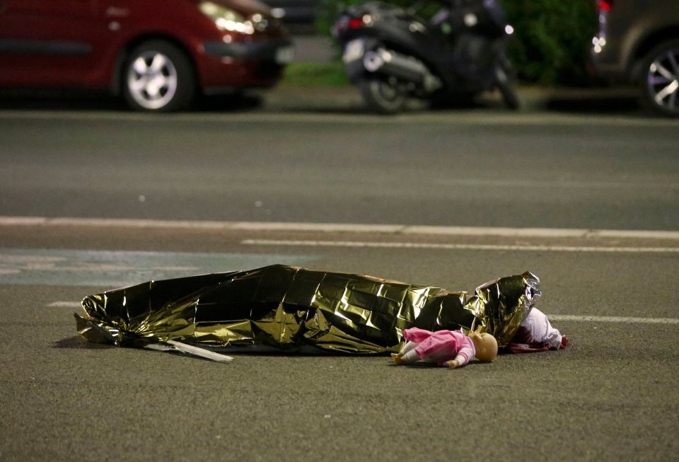 A body is seen on the ground after at least 30 people were killed in the southern French town of Nice when a truck ran into a crowd celebrating the Bastille Day national holiday