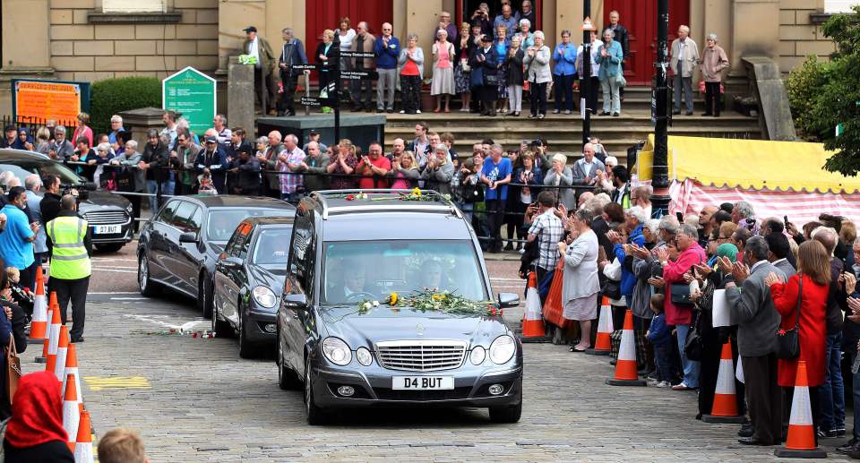 Mourners pay their respects as the funer