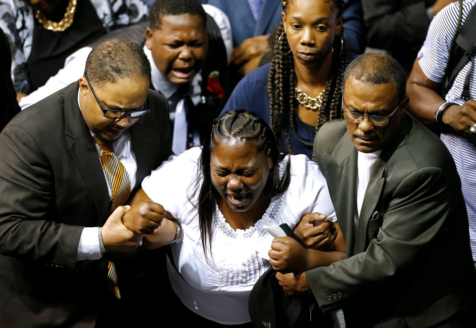 A mourner is carried after the funeral of Alton Sterling, in Baton Rouge
