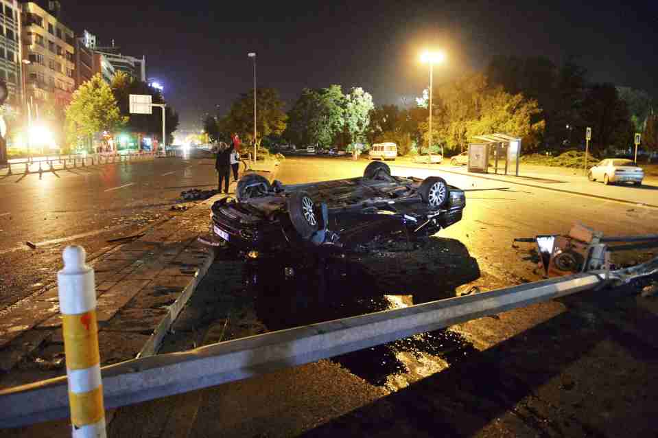 A flipped car lies in a road near military headquarters in Ankara