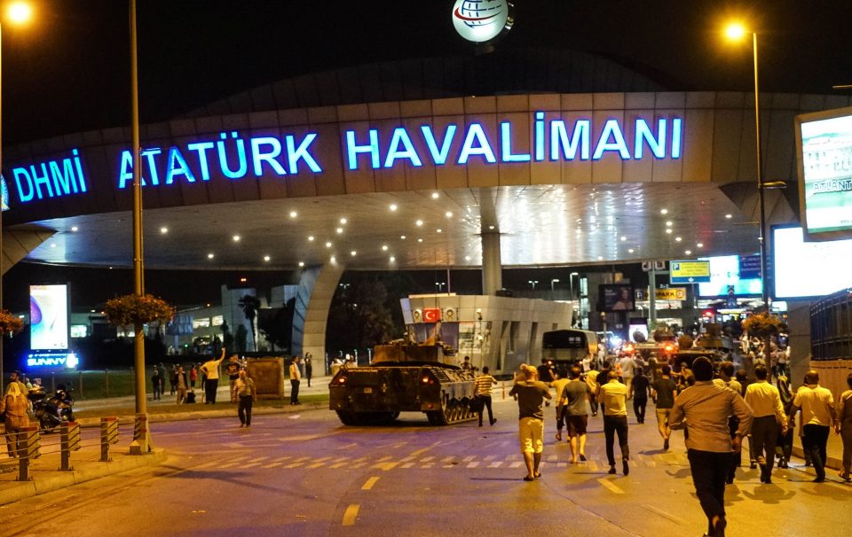 A tank rolls through Ataturk Airport last night during the military coup