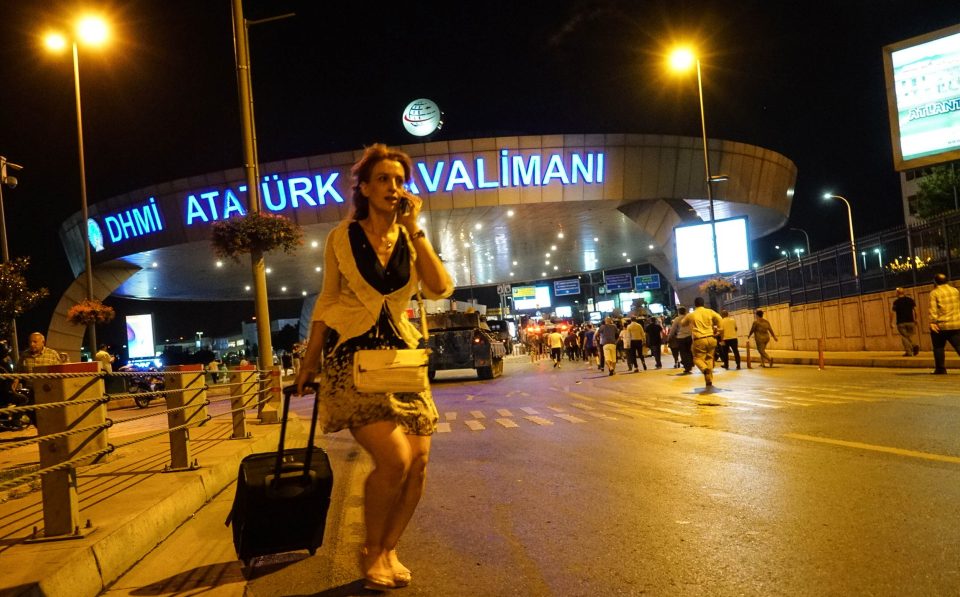A woman leaves the airport with her luggage after the military briefly took control