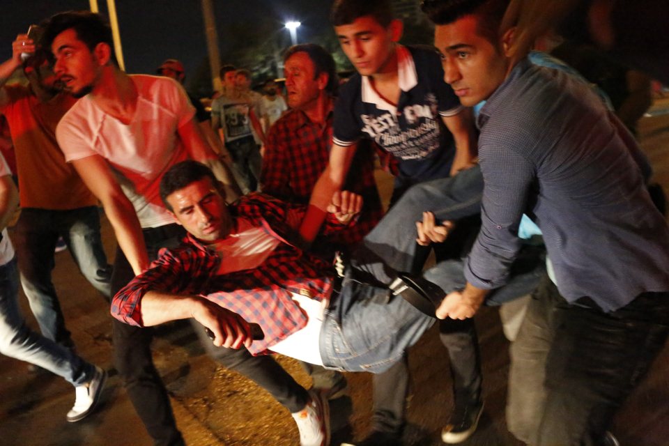 A man is carried away from Taksim Square after loud explosions and gunfire rang out
