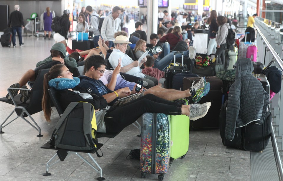 Passengers wait at a packed Terminal 5 on July 16