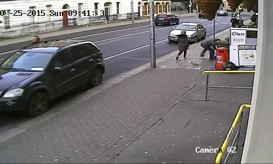 Suddenly the man launches an attack on Fitzgerald while he is sitting on the pavement
