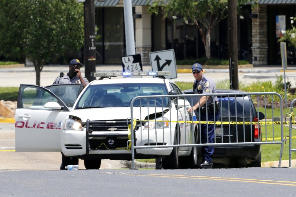 Law enforcement officers block a road after a fatal shooting of police officers in Baton Rouge