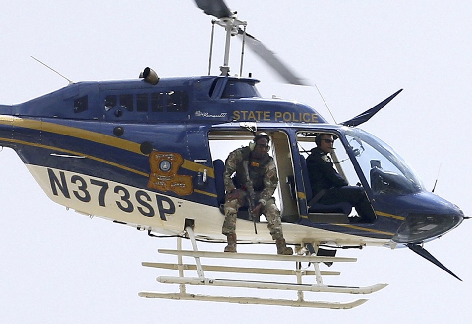A law enforcement helicopter is seen near the scene where police officers were shot in Baton Rouge