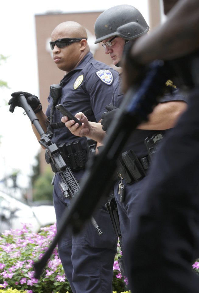 Police officers armed with rifles guard the entrance to Our Lady of the Lake Hospital after a fatal shooting of police officers in Baton Rouge