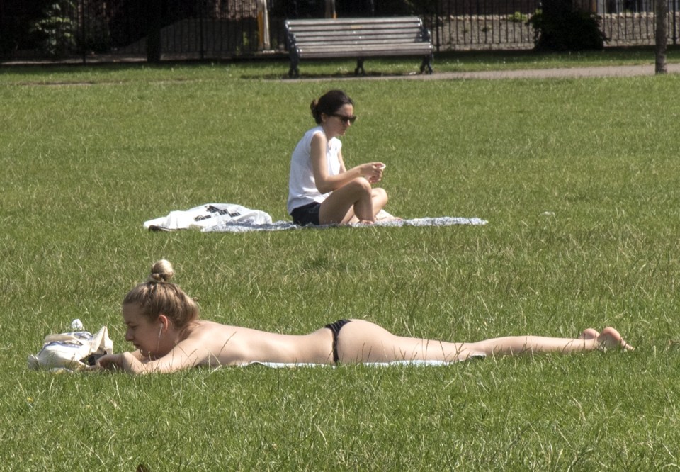 Sunbathers hit Victoria Park this morning - but took care to apply sun lotion in the 29 degree heat